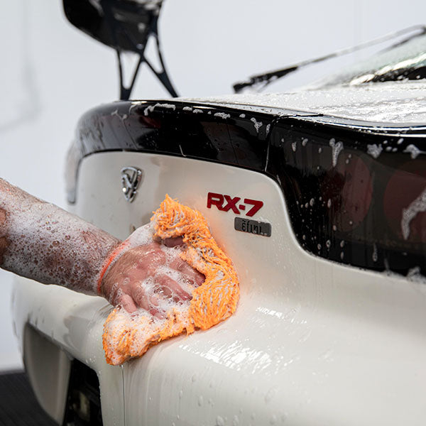 CARPRO DabDab wash mitt in use on a car