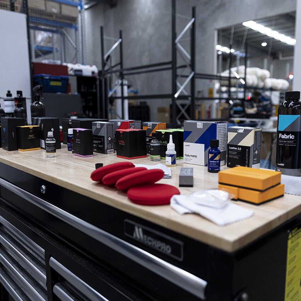 Ceramic coating and paint protection products laid out on a workbench
