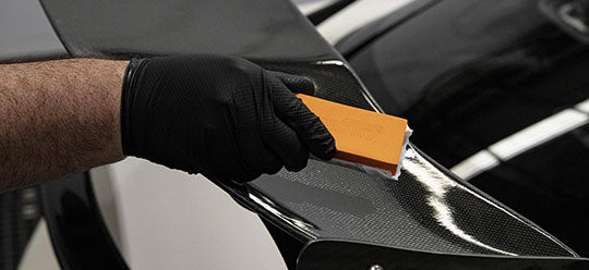 Holding an applicator about to apply coating