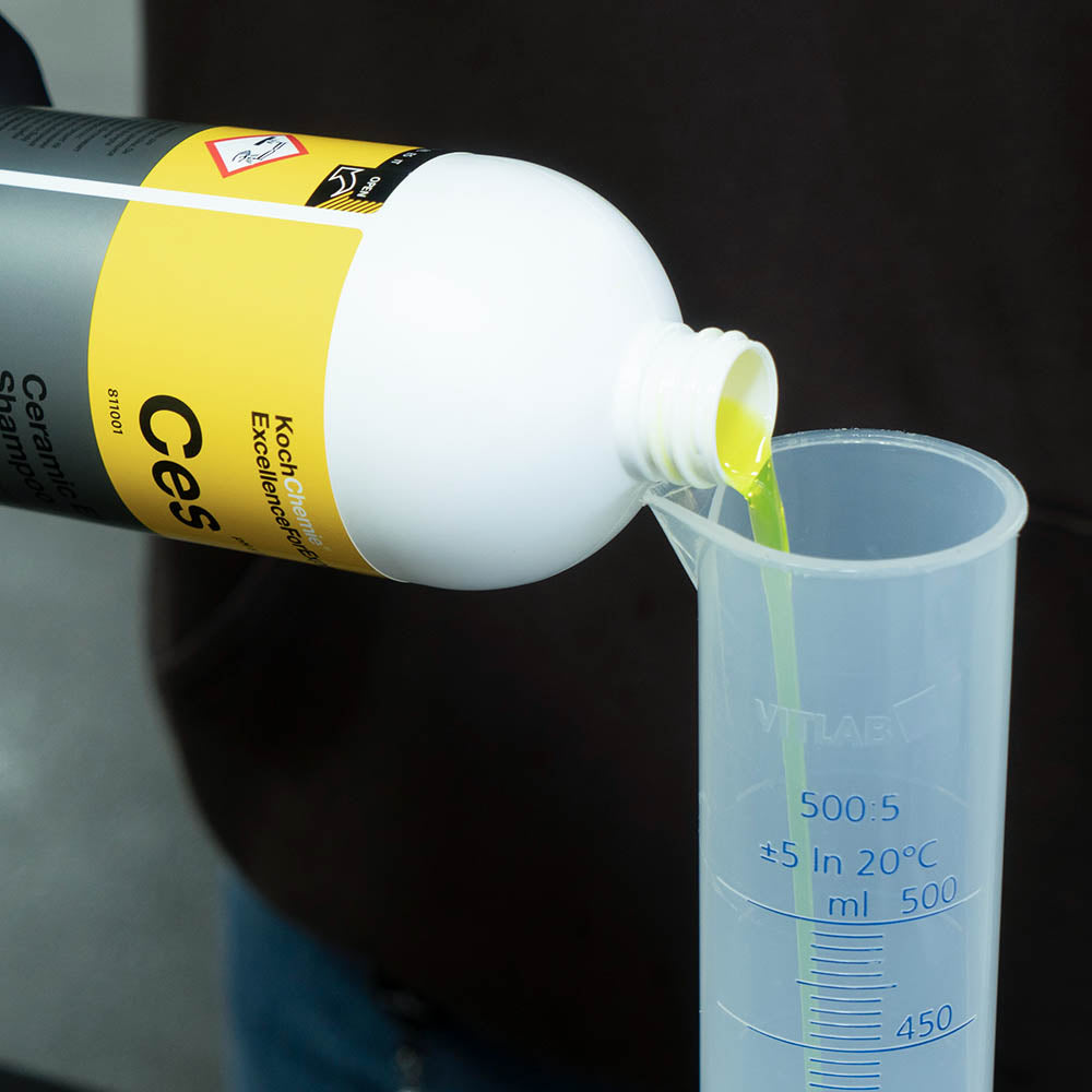 Koch Chemie Ceramic Effect Shampoo | Wash & Wax 1L bottle being poured into a measuring cup.