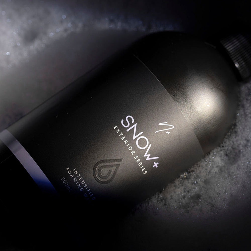 Nv SNOW+ 500 mL bottle lying in foam
