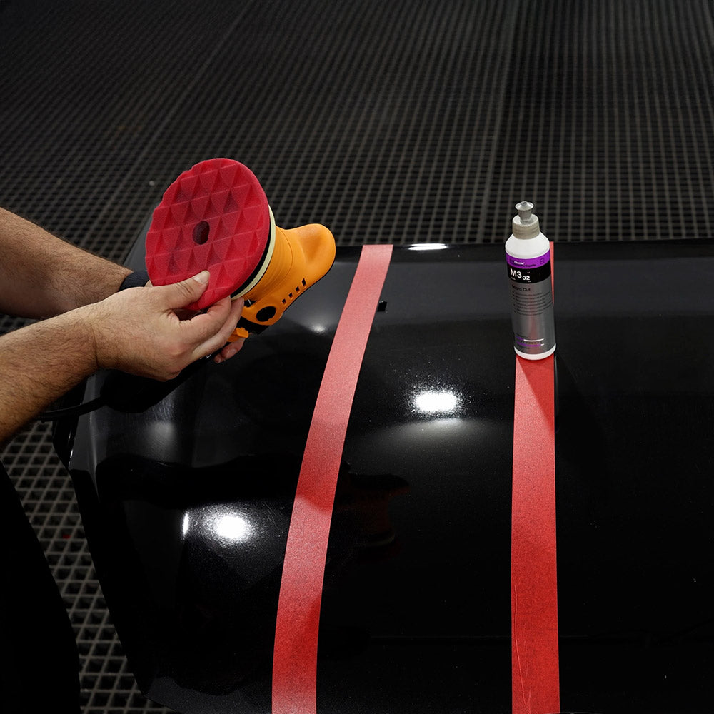 ShineMate ERO600 polisher with a red pad on a Koch Chemie M3.02 test section