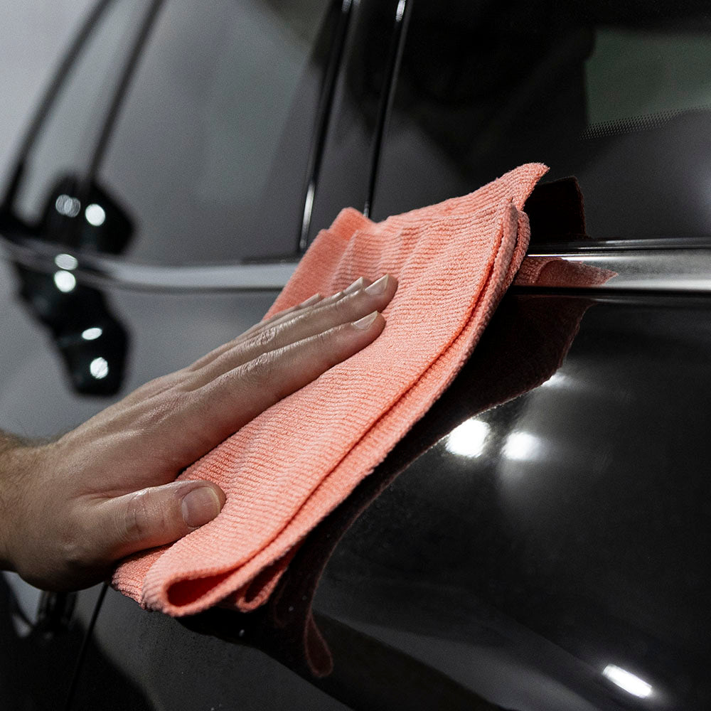 Aquatouch ACE microfiber cloth wiping a black panel