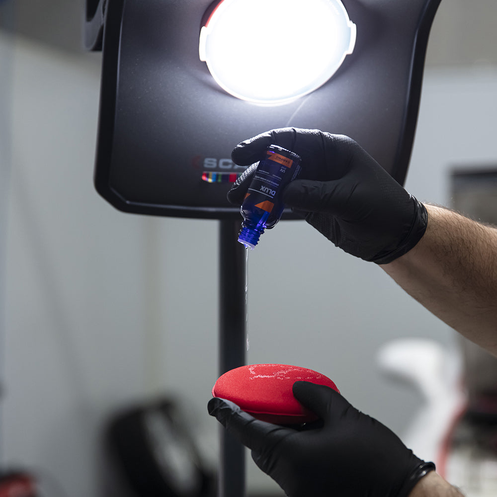 Pouring CARPRO DLUX onto applicator pad