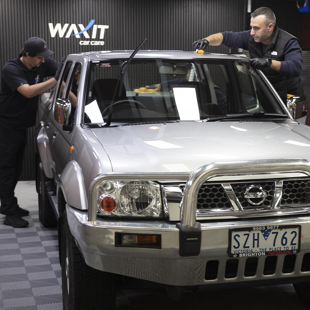 People from the training course coating a silver car