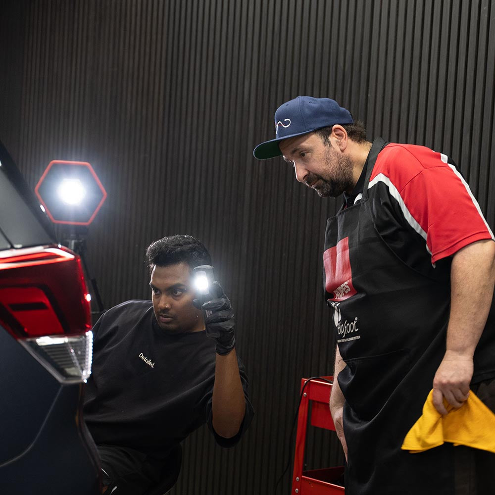 Teacher showing how to see swirl marks with a scangrip light