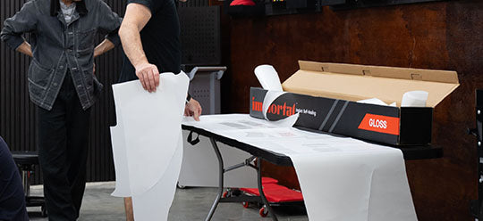 A person cutting a section of Immortal Gloss PPF