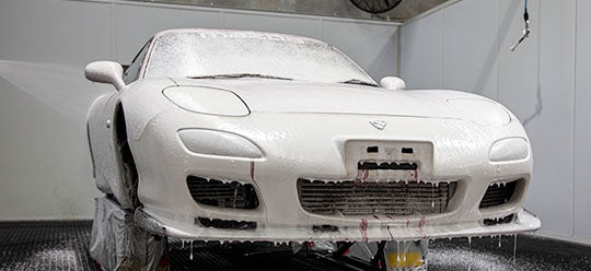 RX7 covered in soap in a washing bay