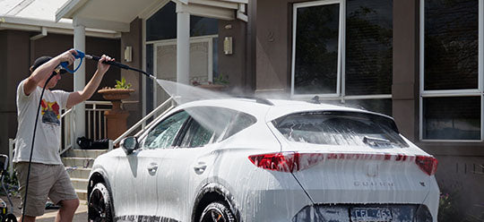 An Annovi Reverberi gun and hose upgrade kit being used to wash a white car