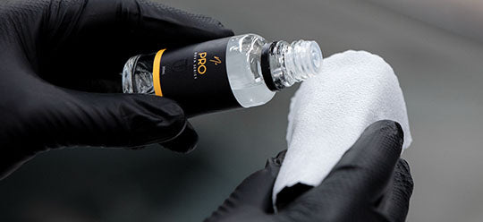 A person applying NV Pro to a suede applicator