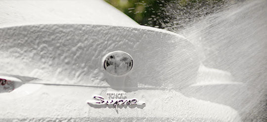 Spraying foam onto white car