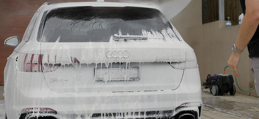 Rinsing off foam from a white car