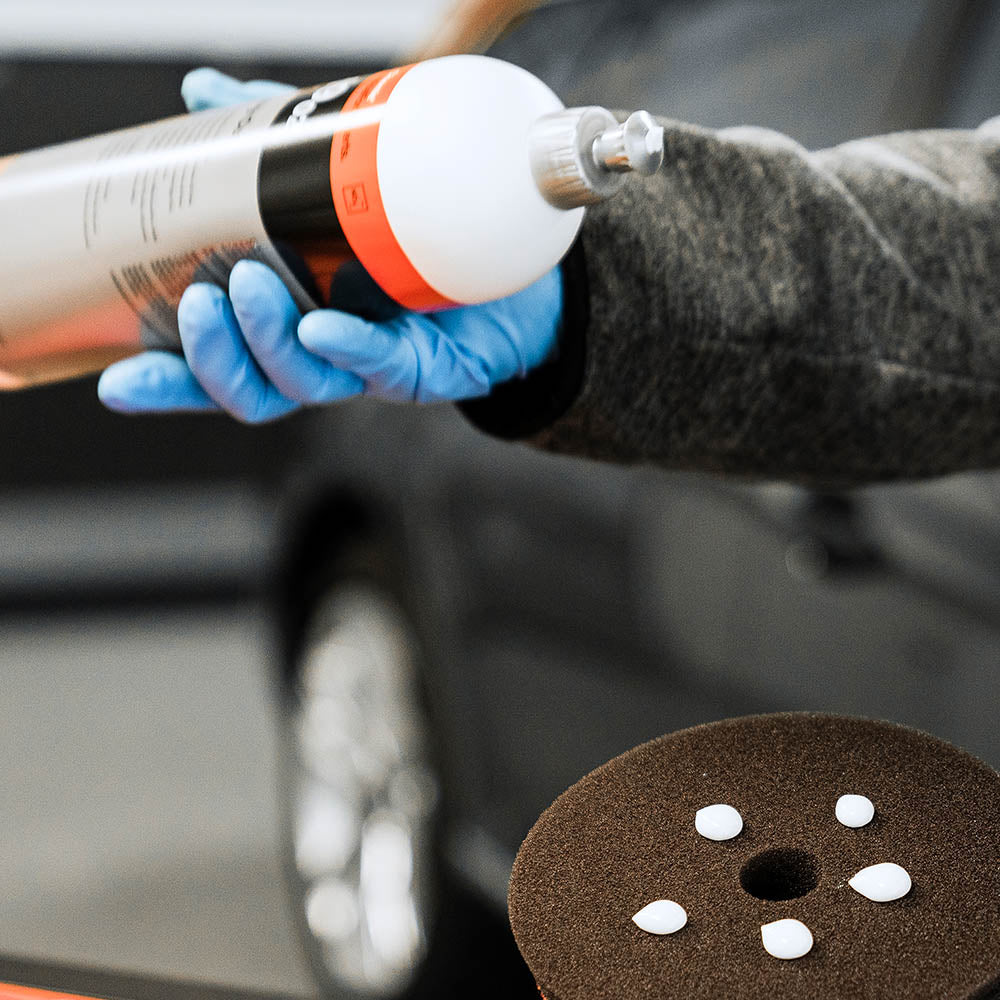 Koch Chemie Heavy Cut H9.02 being applied to a black polishing pad