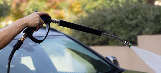 An person washing a car using an Annovi Reverberi gun and lance upgrade kit