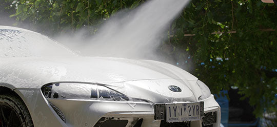 White sports car being washed with an Annovi Reverberi pressure washer